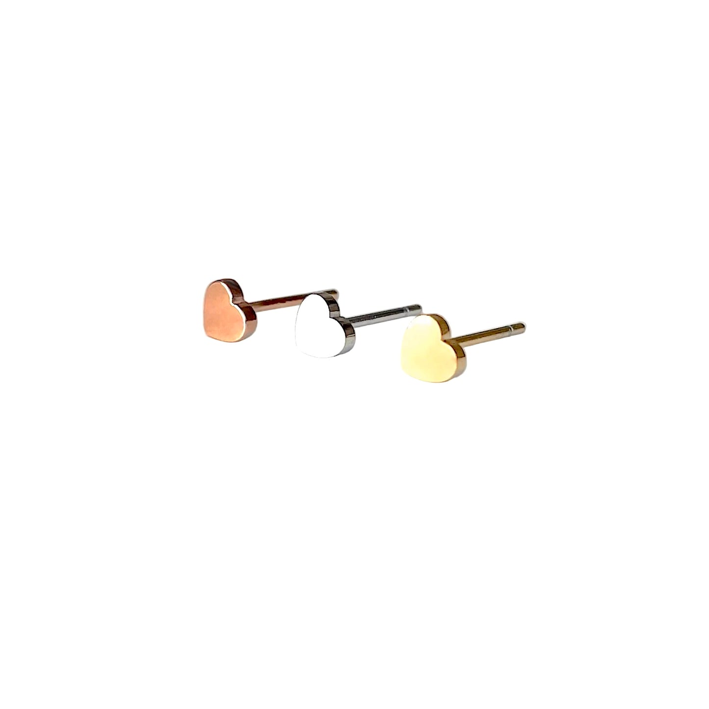 3 heart earrings in gold, silver and rose gold on a white background