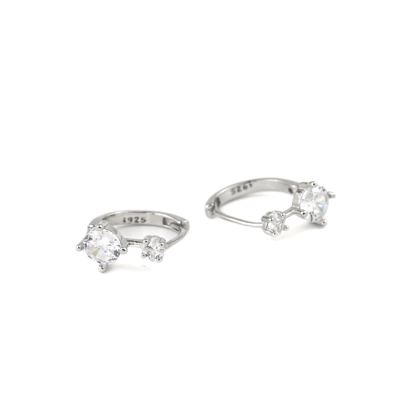 silver huggie earrings with one small and one medium sized CZ and S925 hallmark