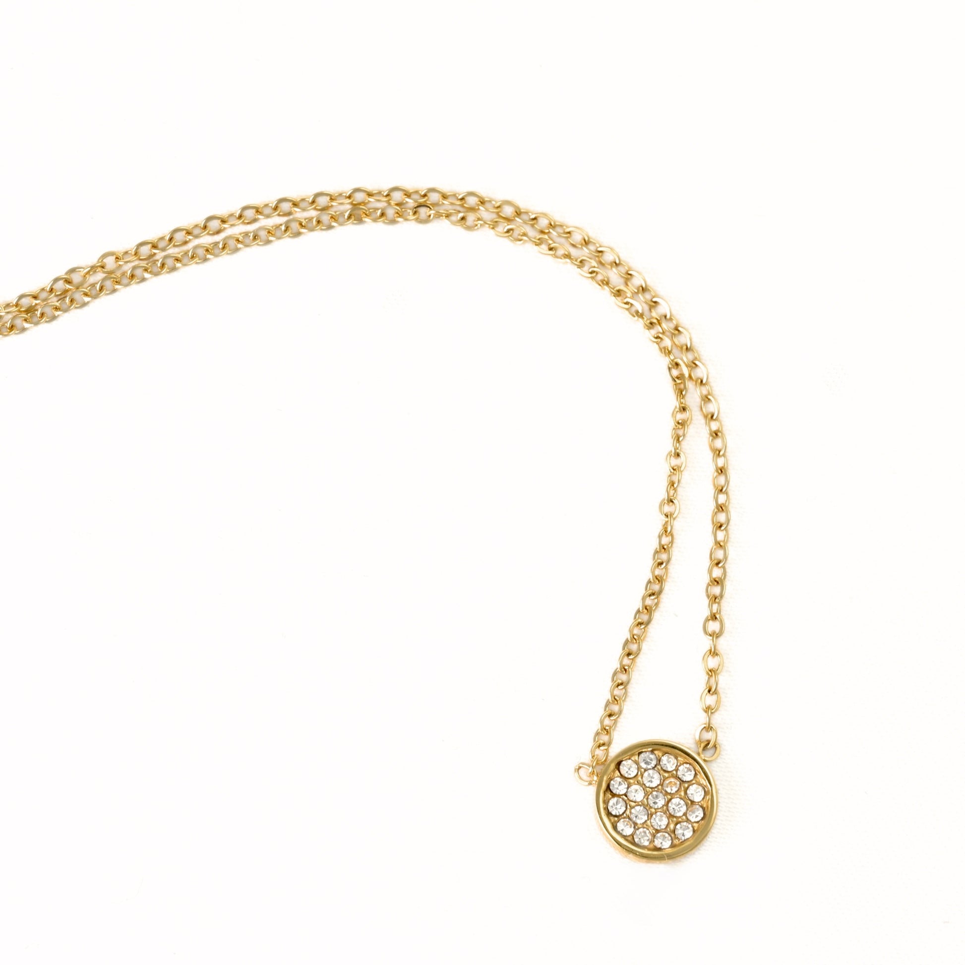 A gold chain necklace featuring a delicate pavé-set circular pendant on a clean white background.