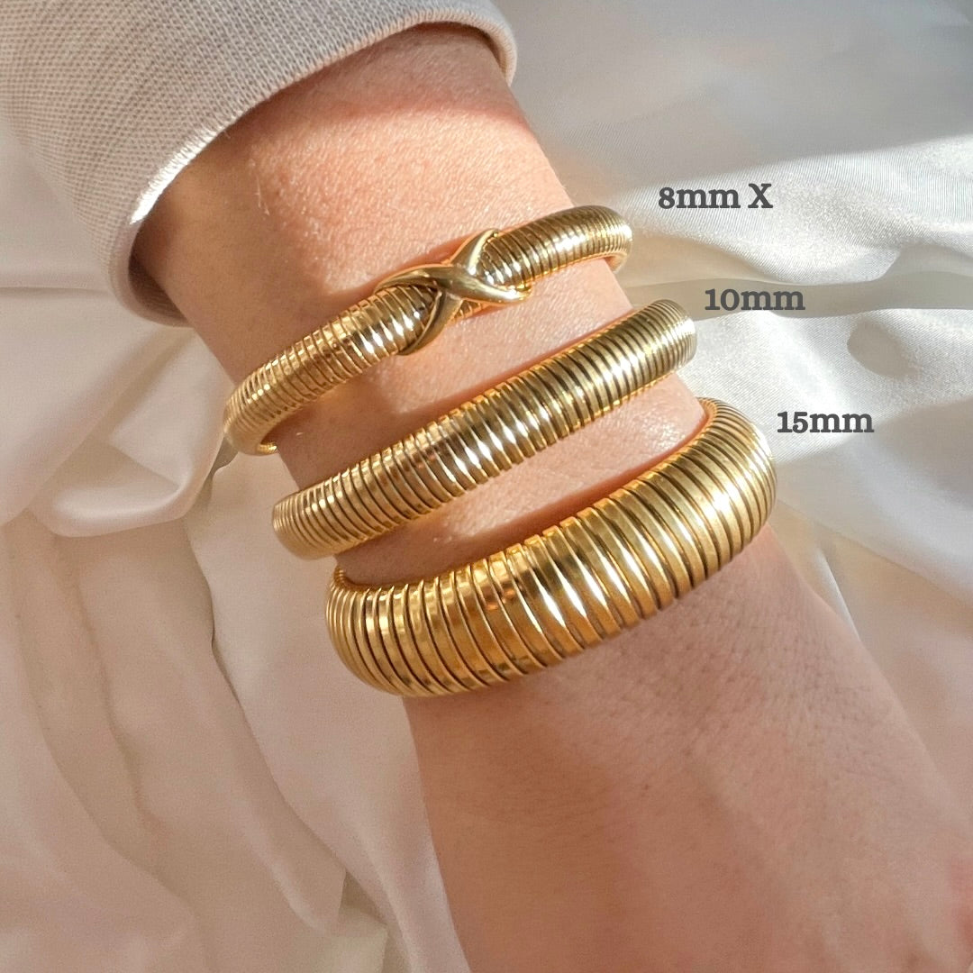 Three gold tubogas bracelets, from oversized to dainty with an X knot on a wrist with size measurements