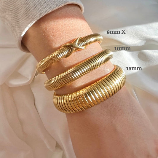 Three gold tubogas bracelets, from oversized to dainty with an X knot on a wrist with size measurements
