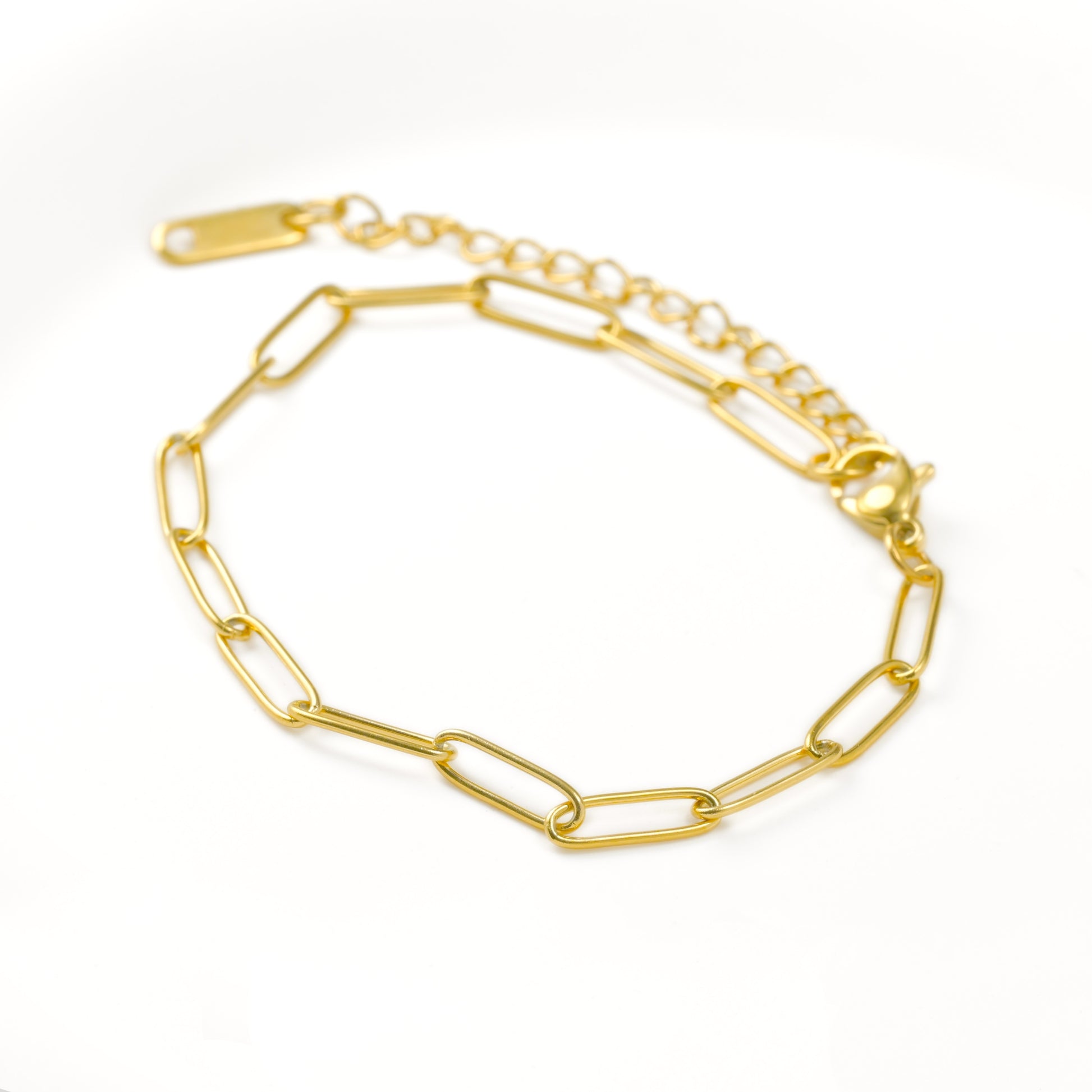 Gold chain bracelet with paperclip links on a white background