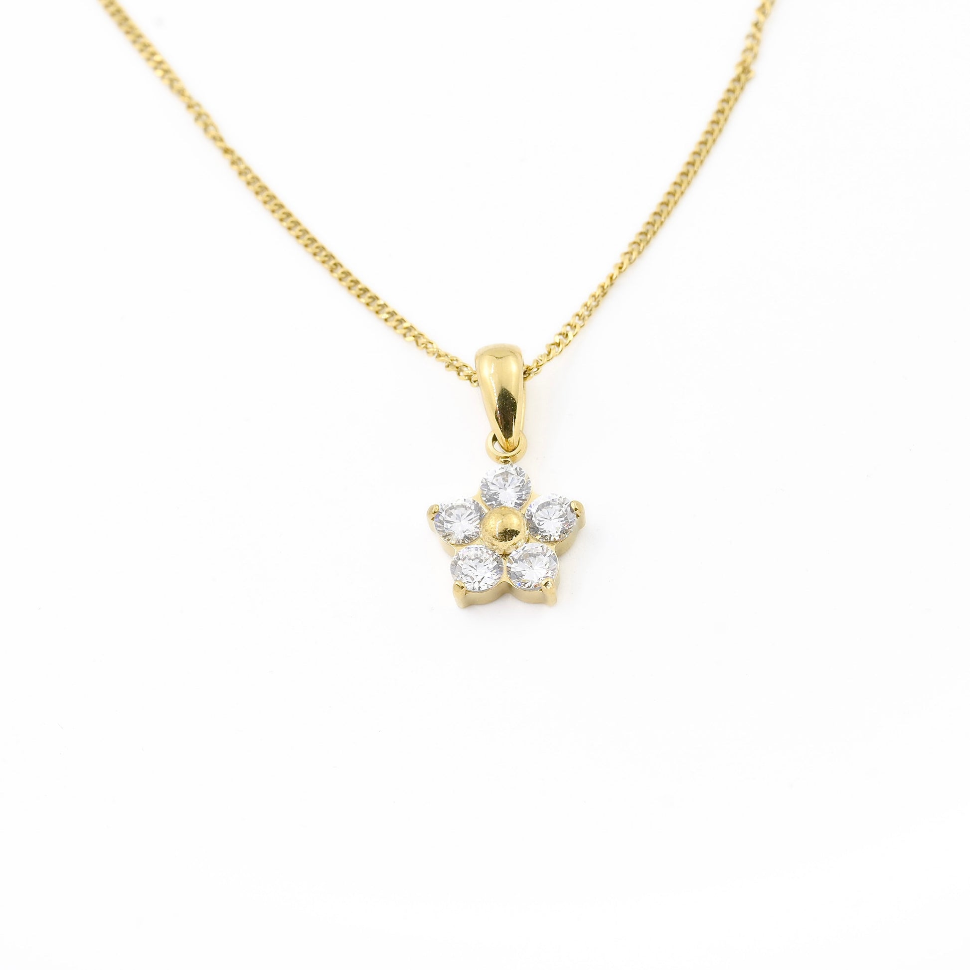 Gold curb chain necklace with a flower-shaped pendant on a white background