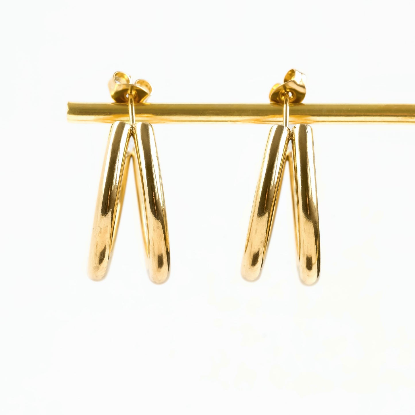 Gold earrings on a white background