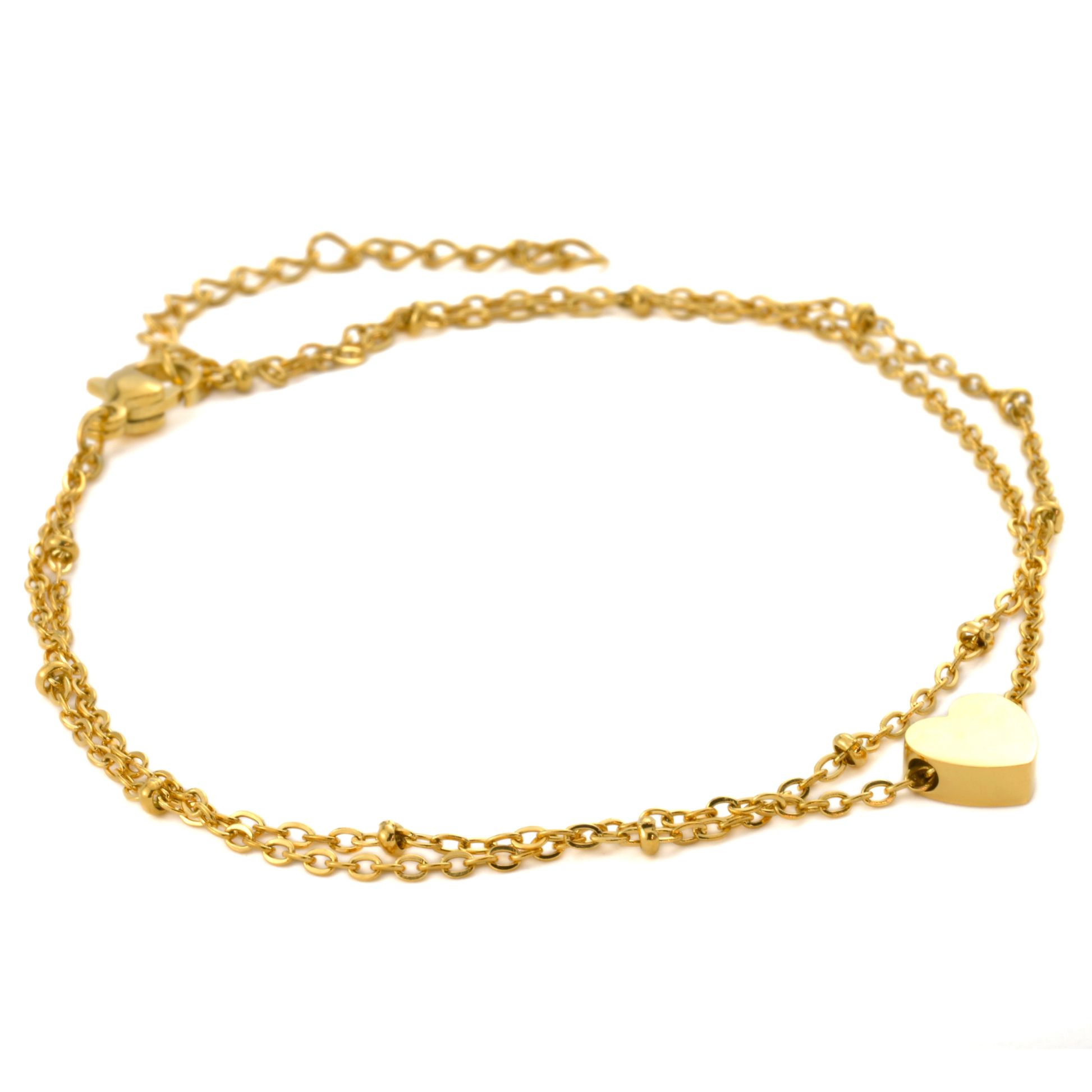Double strand gold chain ankle bracelet with a flat heart charm on a white background