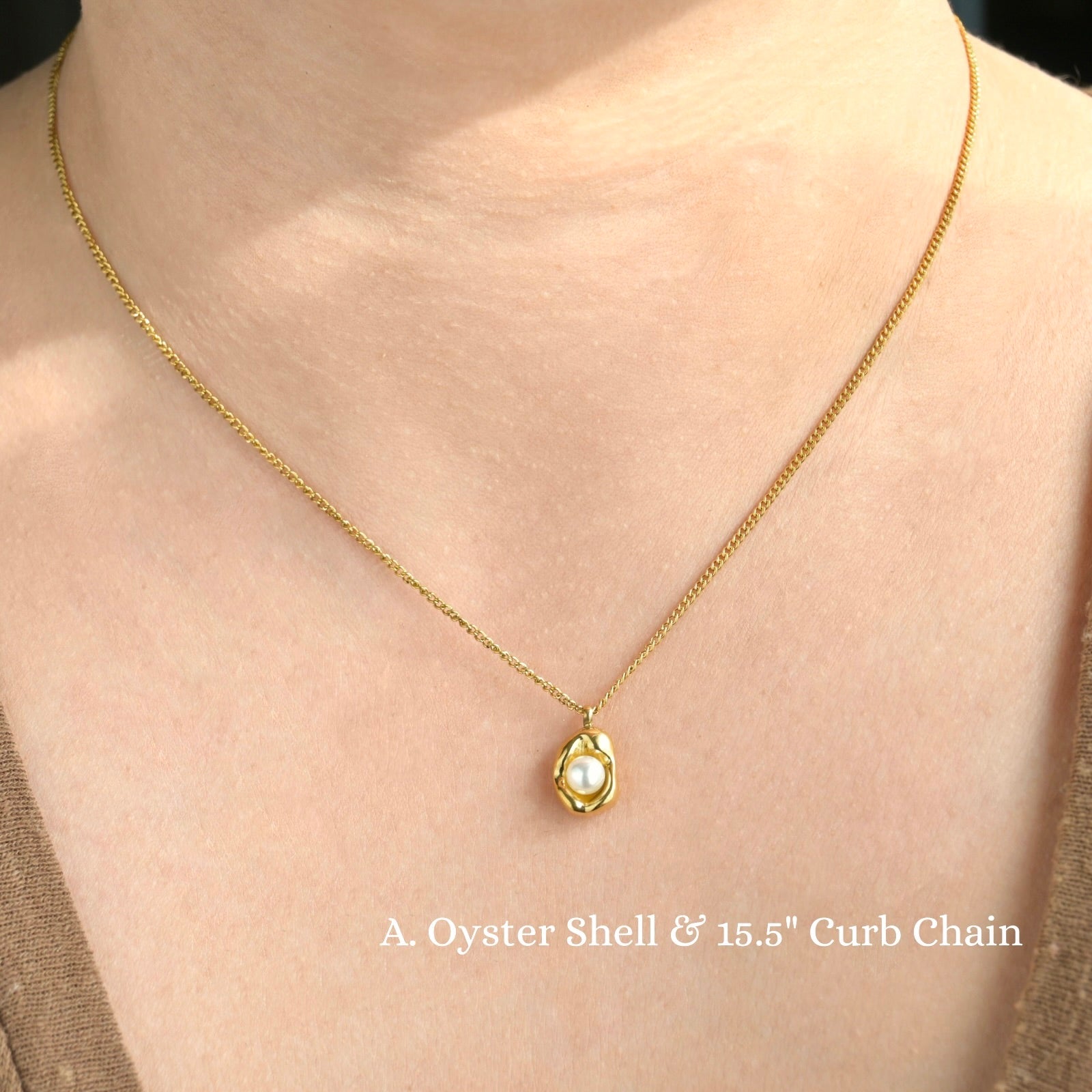 Stainless Steel gold necklace with an oyster shell pendant on a person's neck