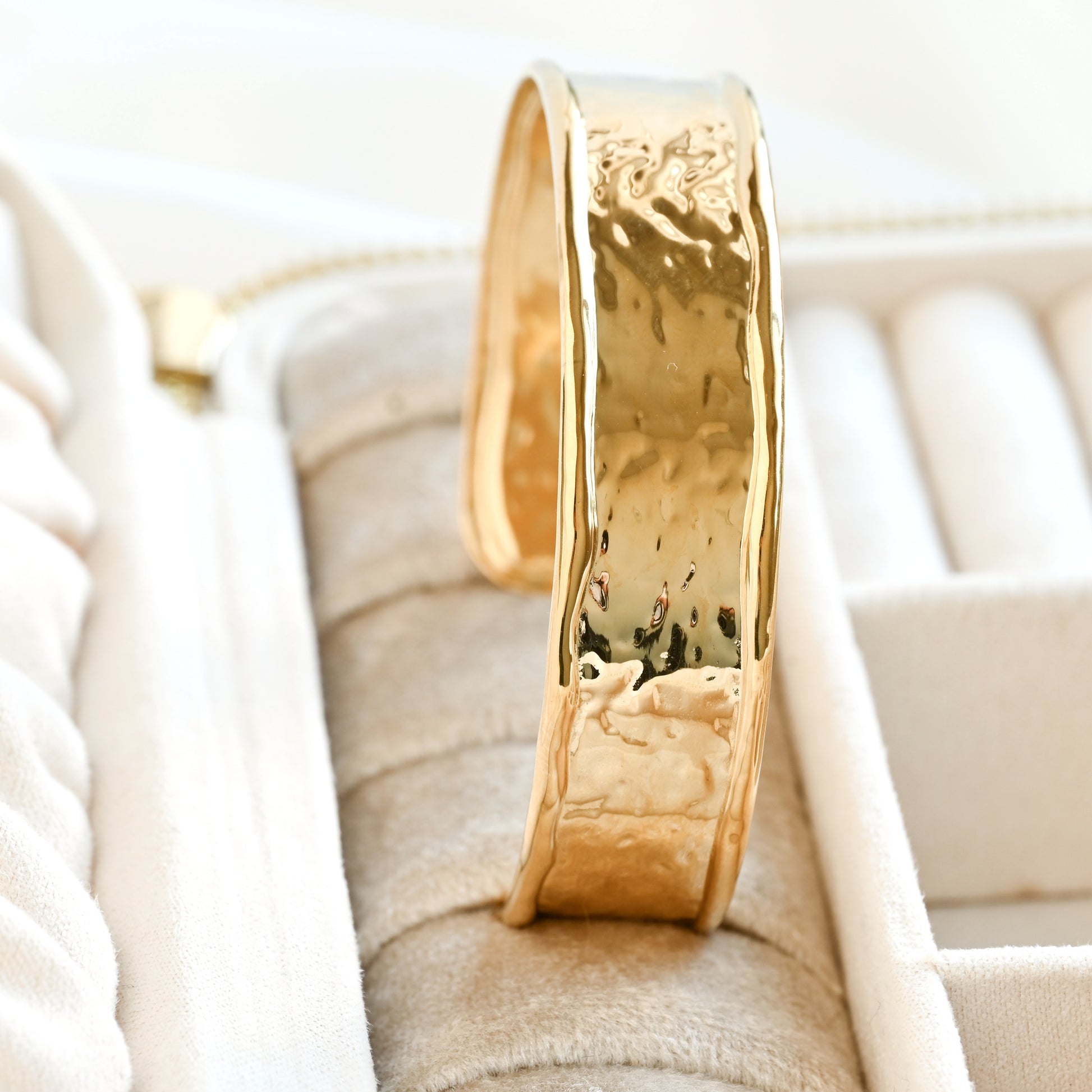 Gold cuff with textured design in a jewelry box