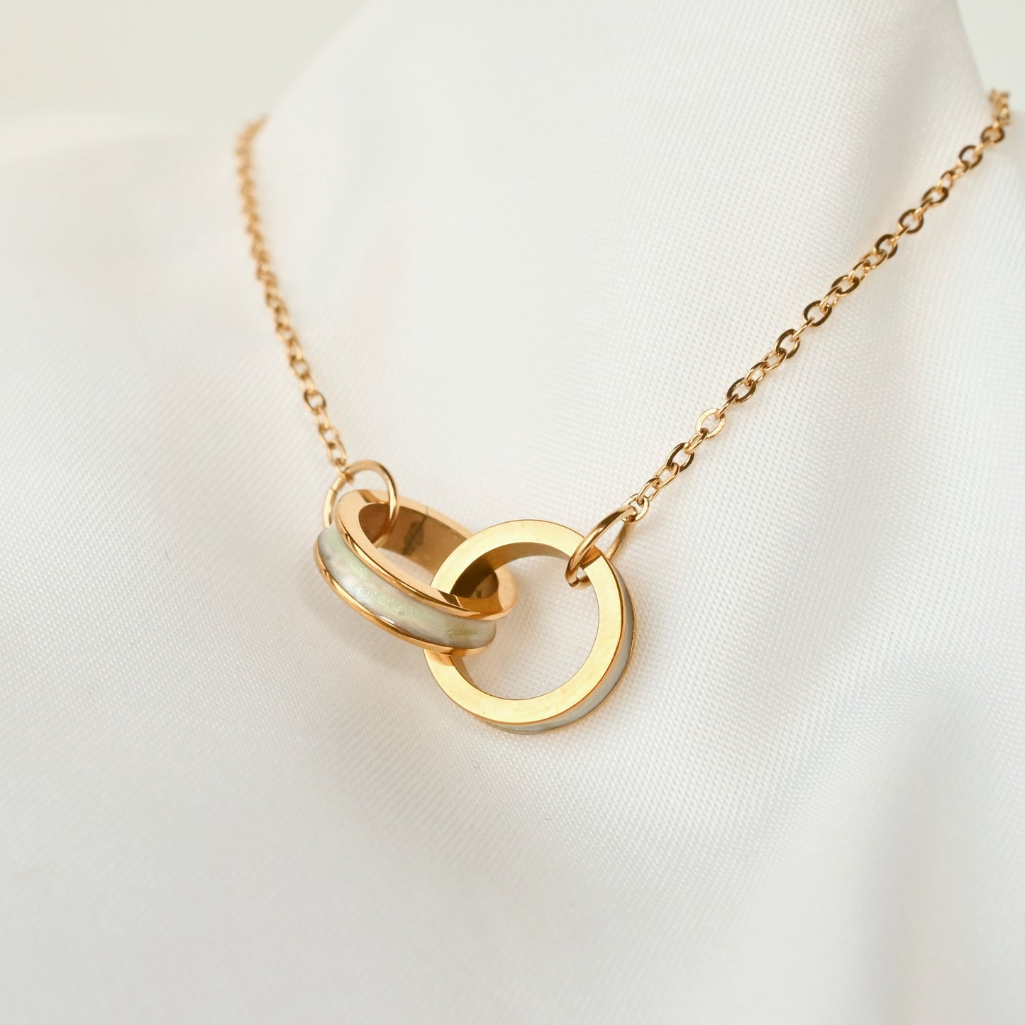 Dainty Gold bracelet with double rings  with shell inlay on a white background