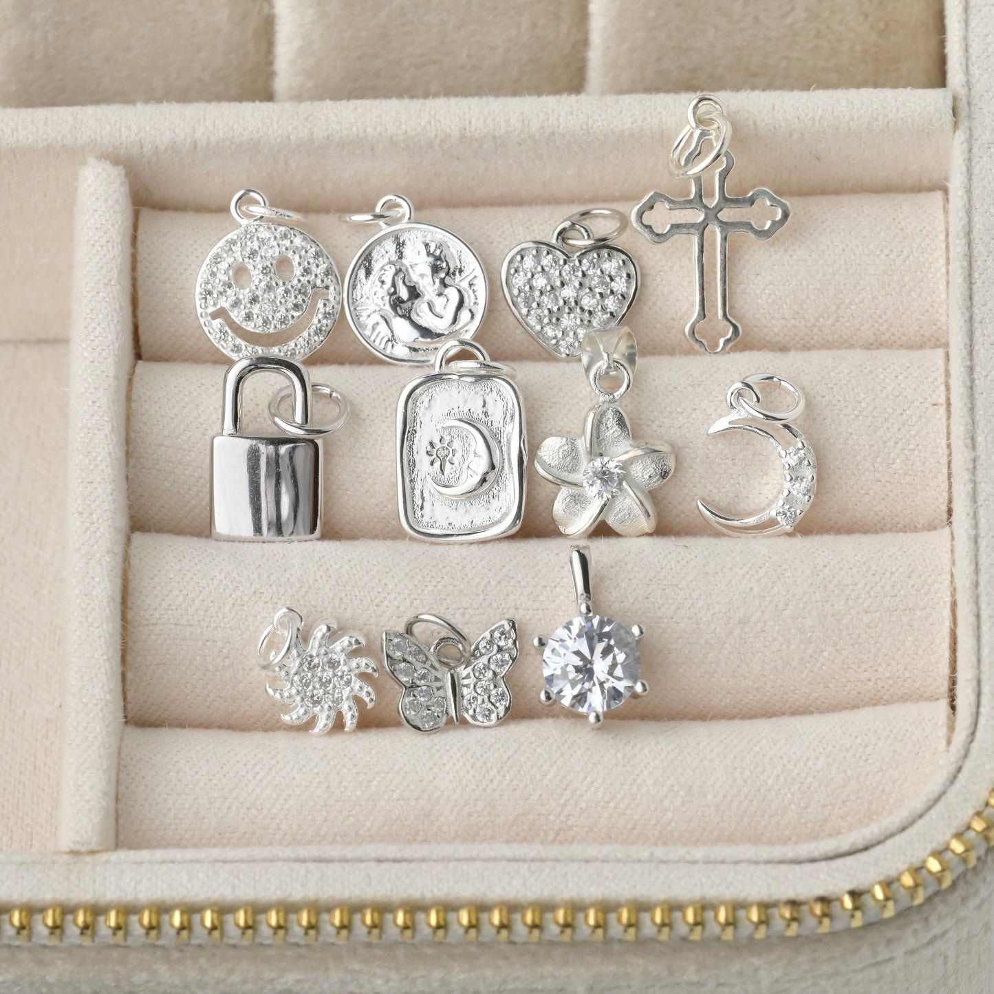 Top view: Collection of silver pendants in a jewelry case