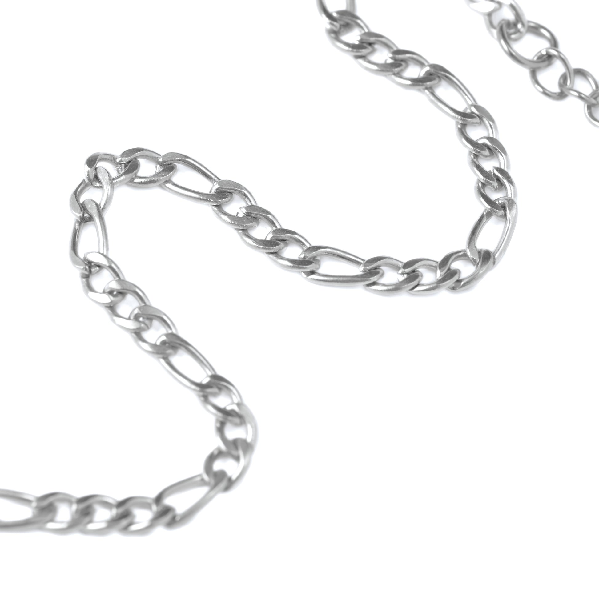 Close-up of Silver figaro chain on a white background