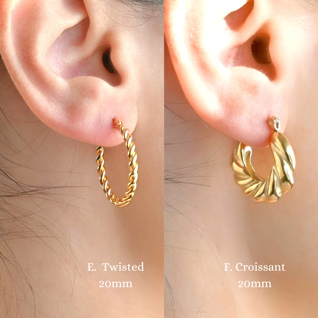 Two gold hoop earrings, one thin and twisted and one bold croissant, worn on ears with labels indicating their names and size.