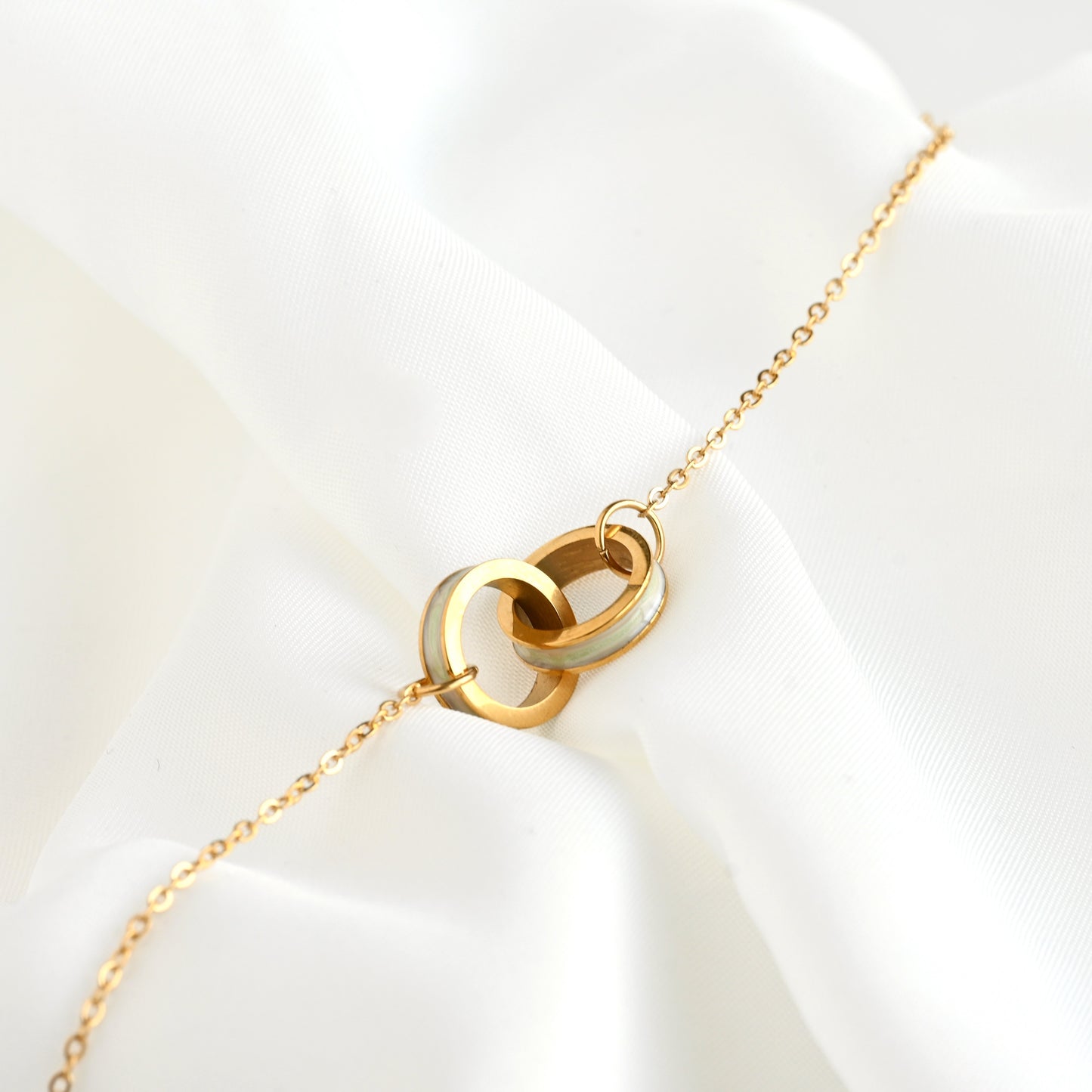 Gold PVD Plated bracelet with circle charm on a white background