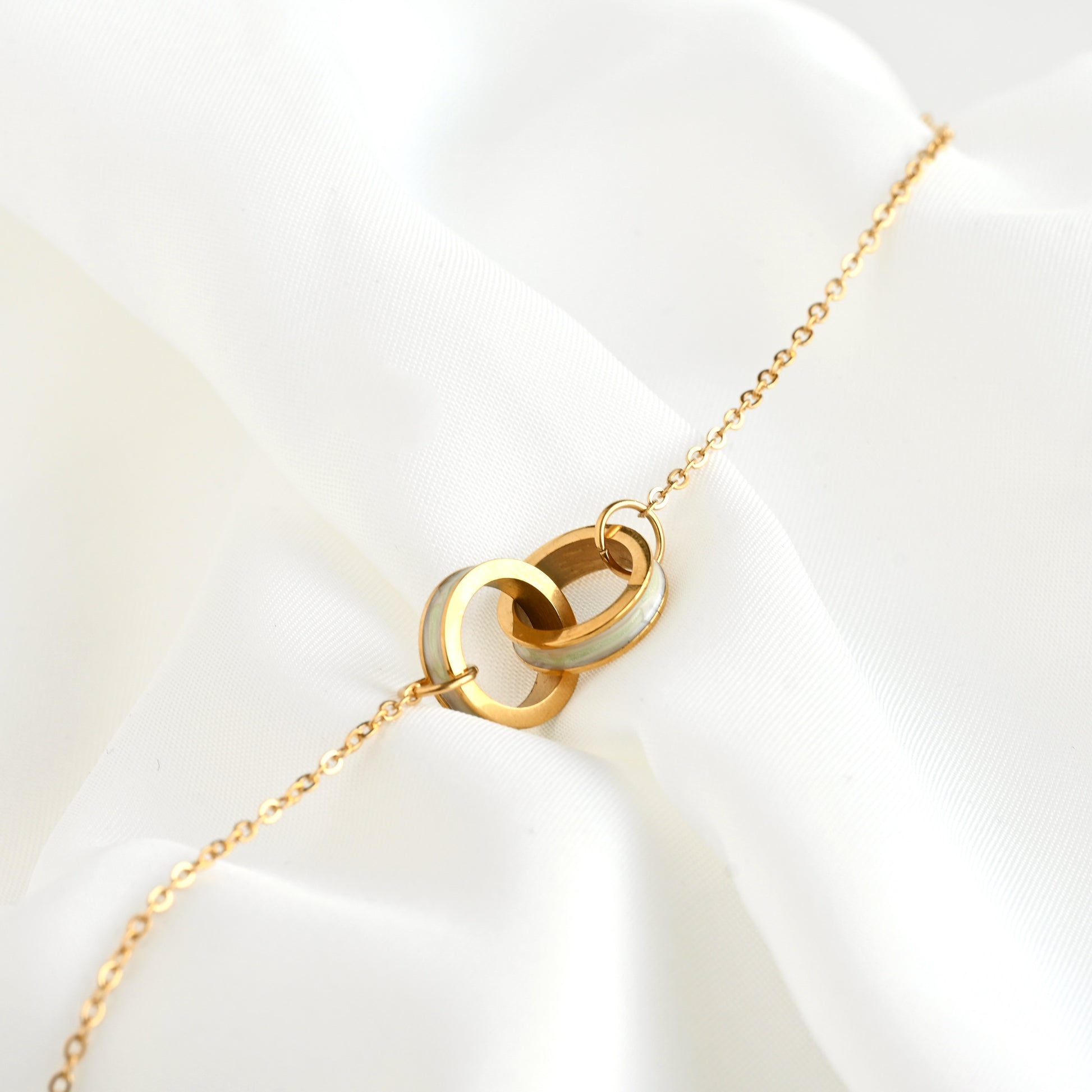 Gold PVD Plated bracelet with circle charm on a white background