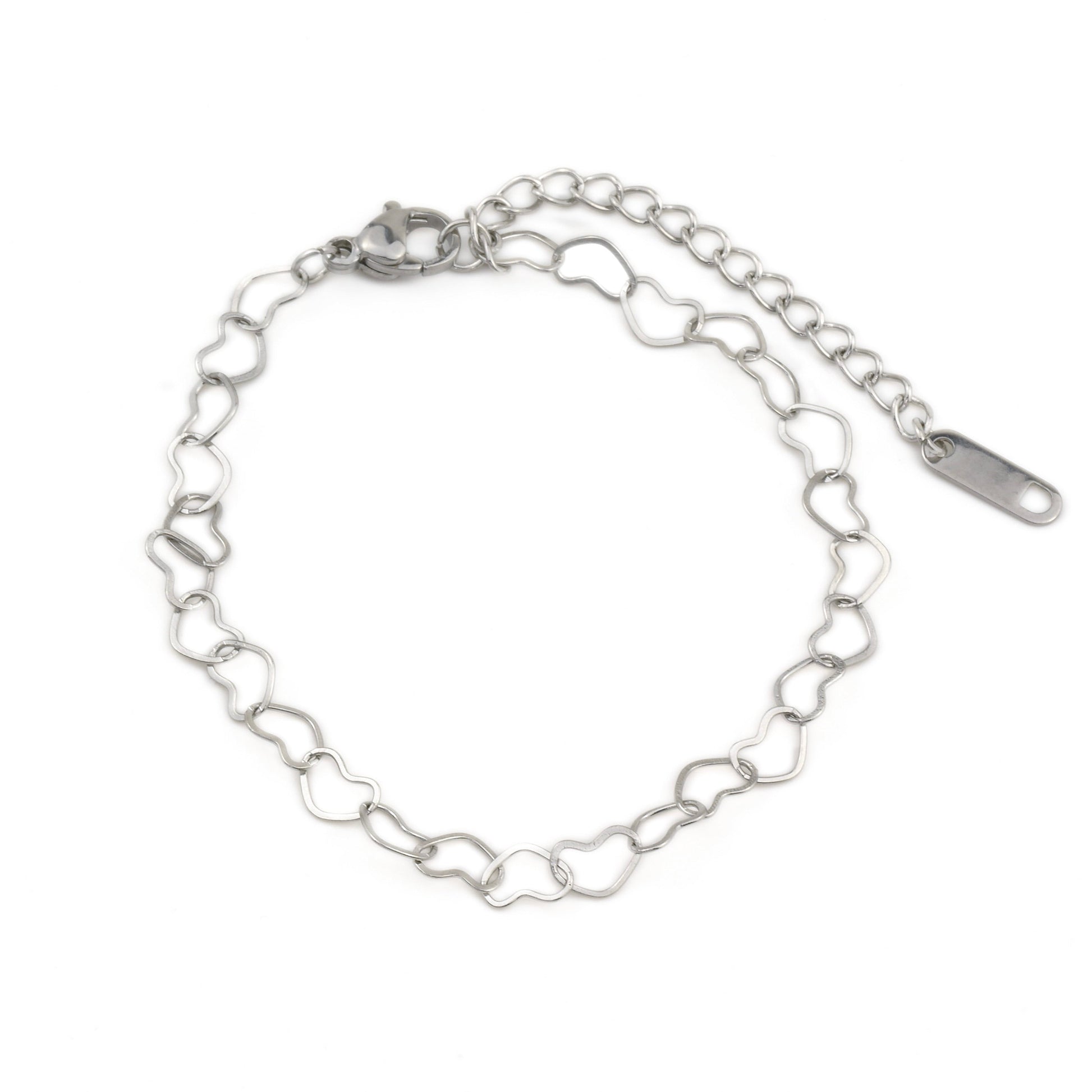 Silver heart-shaped link chain bracelet on a white background with a lobster claw clasp and 'stainless steel' hallmark tag at the end