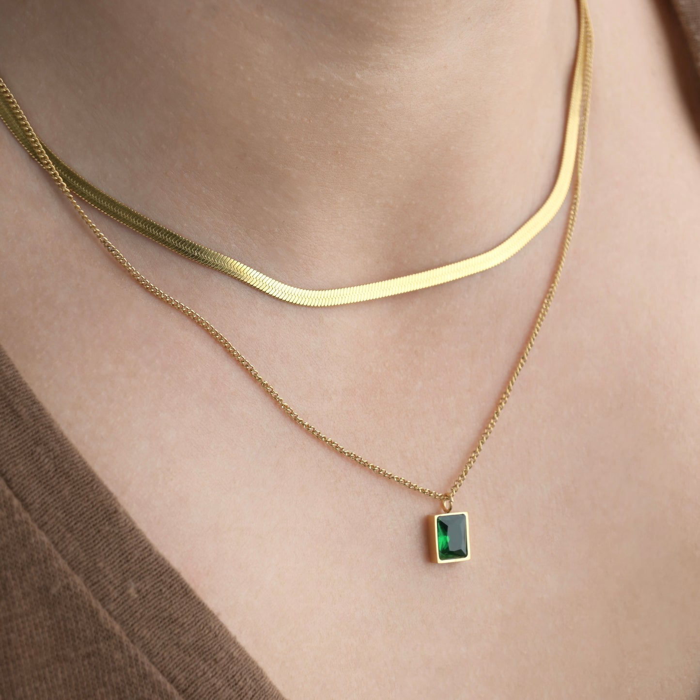 Gold herringbone and thin curb chain necklace with a rectangle emerald green stone pendant