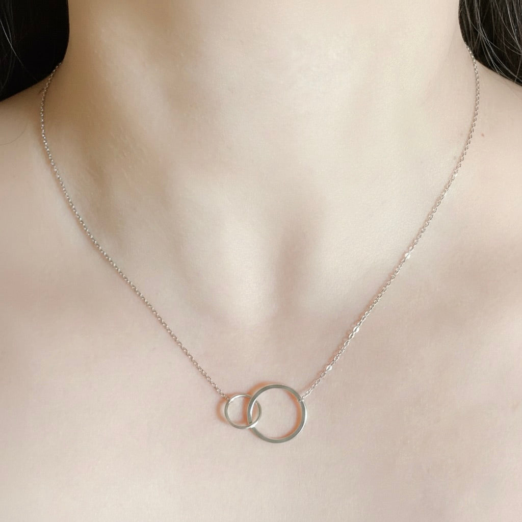 Silver necklace with interlocking rings on a mannequin