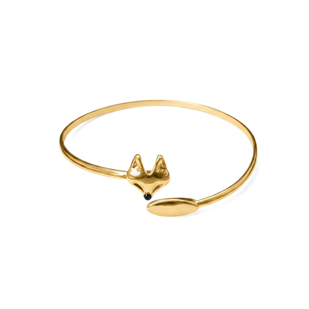 Gold cuff bracelet with fox head and tail on each end on a white background