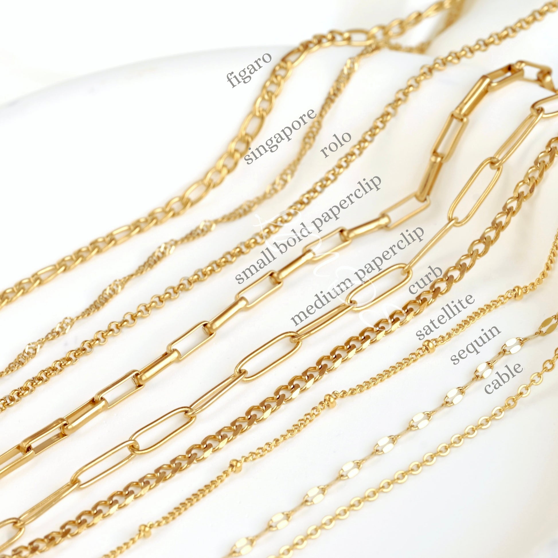 Gold chains with various designs on a white background