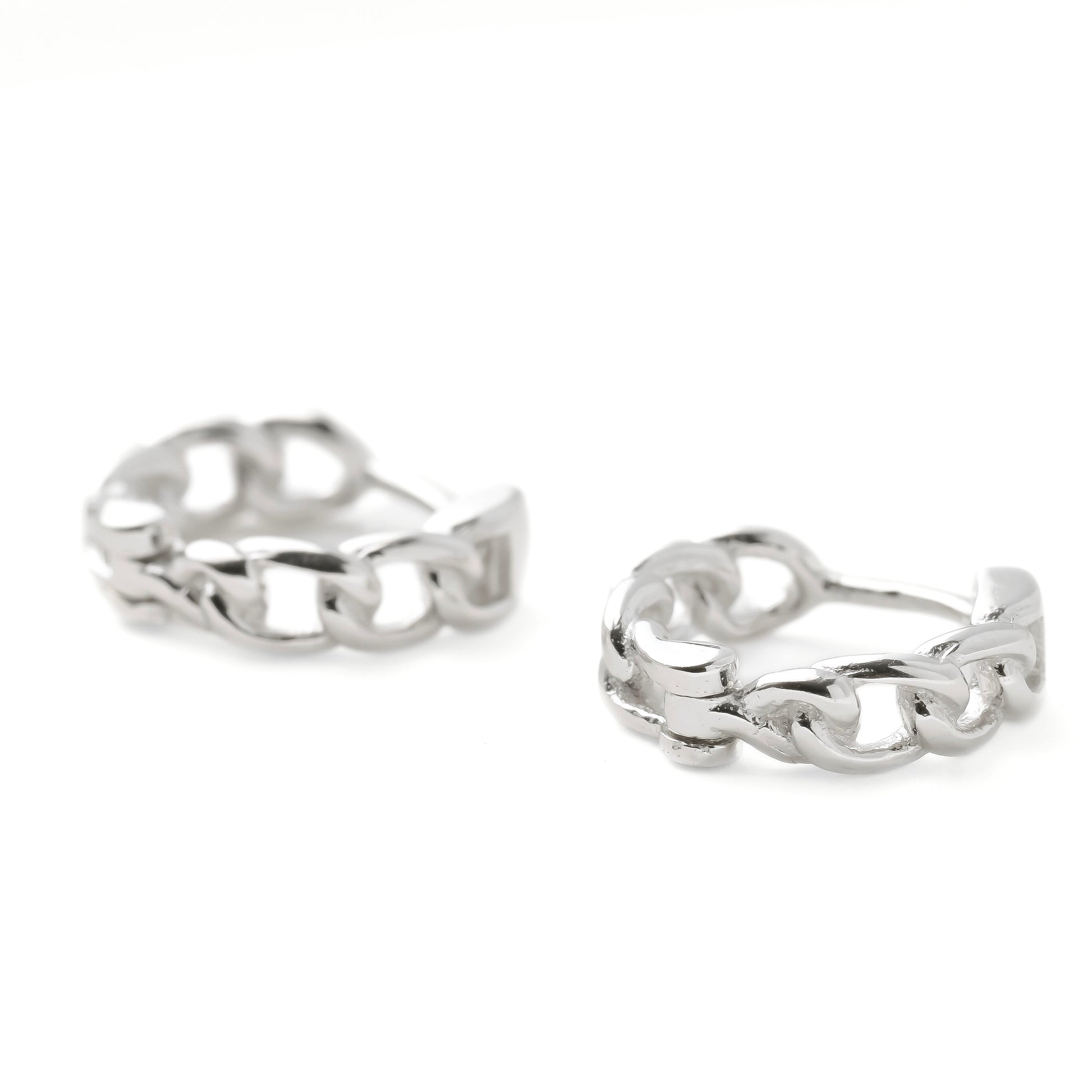 Pair of silver curb chain-link earrings on a white background