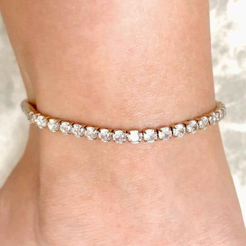 Simulated diamond ankle bracelet on a person's ankle with a soft background