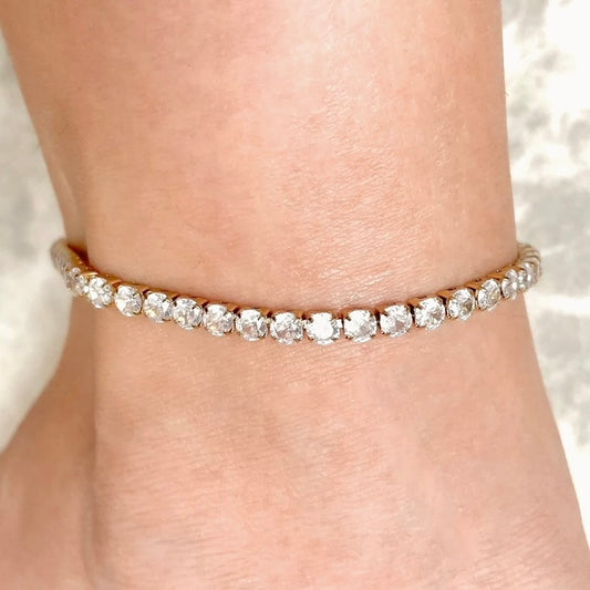 Simulated diamond ankle bracelet on a person's ankle with a soft background