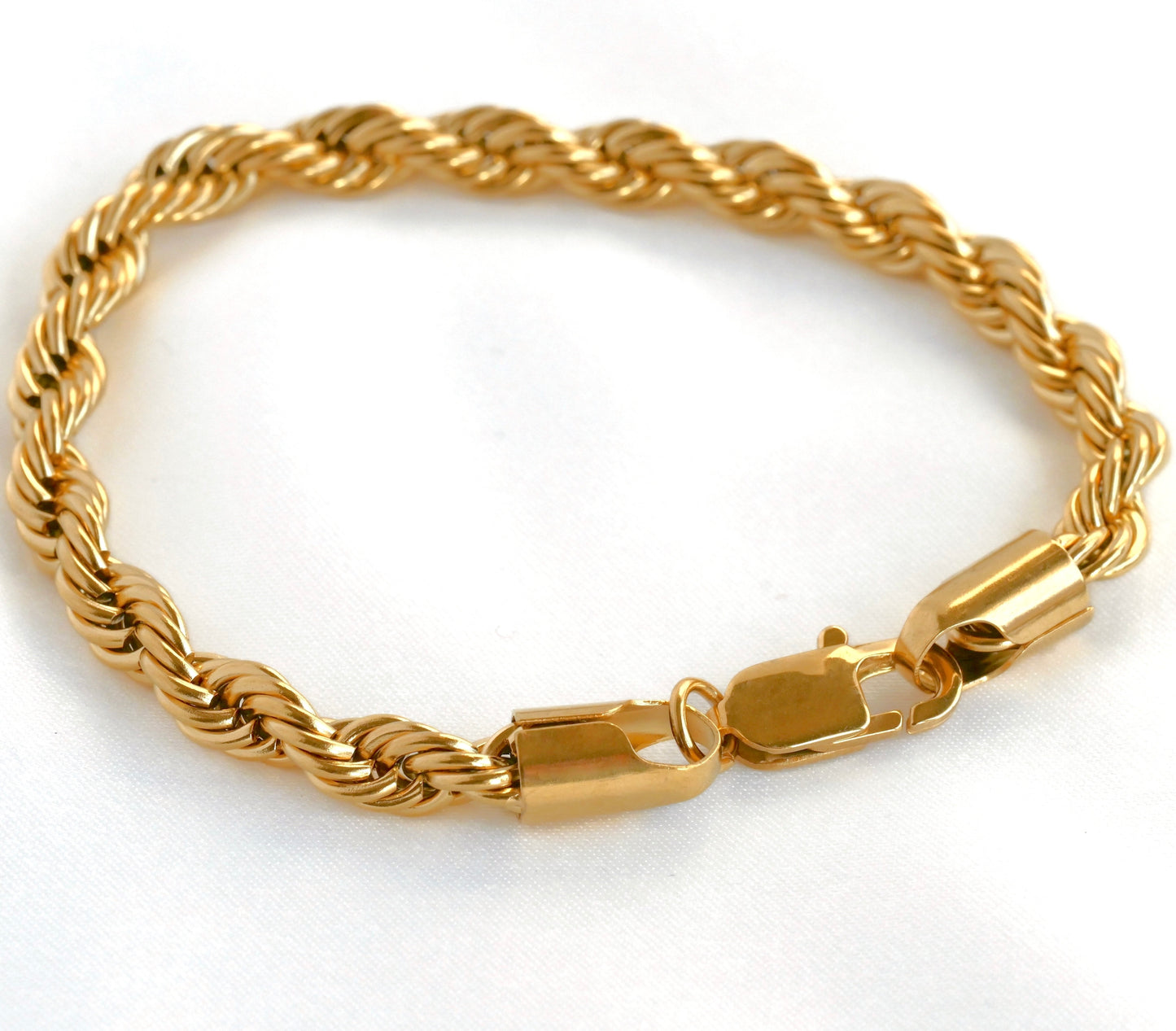 Chunky gold rope chain bracelet on a white background