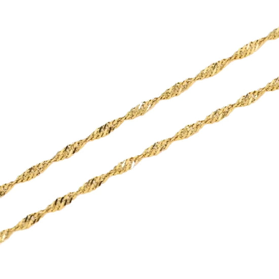 two gold twist chains shimmering as they catch light