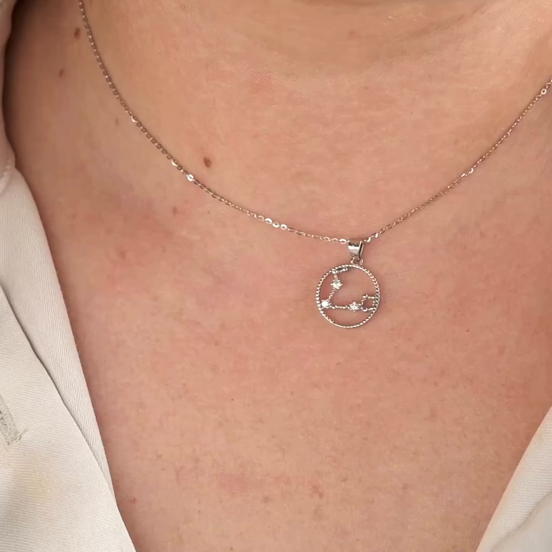 women wearing round star sign pendant showing it from different angles