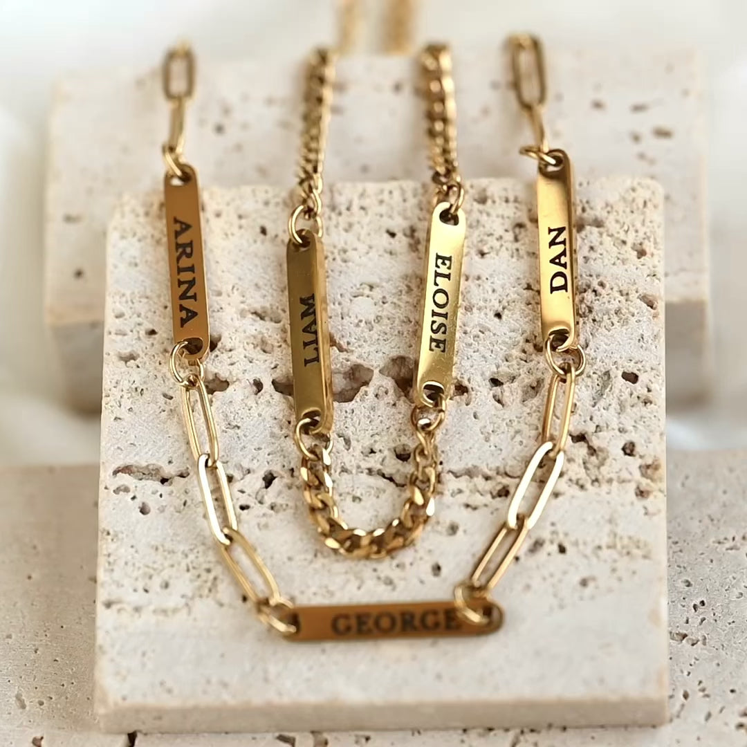 video showing  two family name bar bracelets with paperclip and curb chains