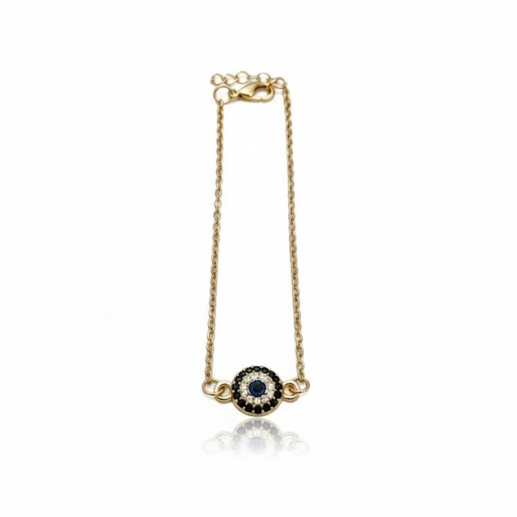 Gold anklet with a blue gemstone pendant on a white background
