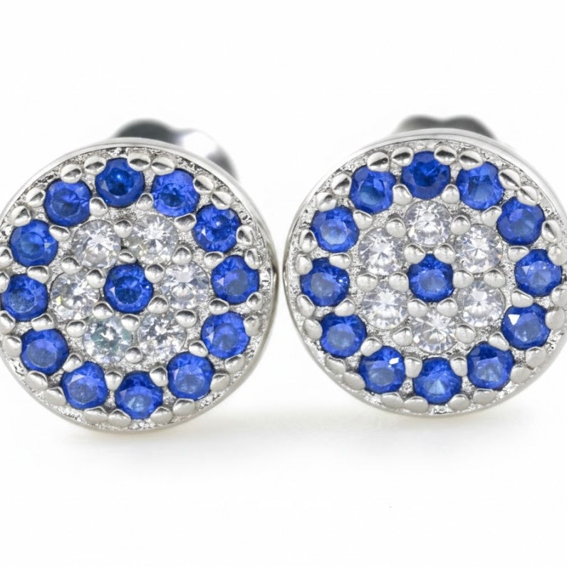 Close-up view of round CZ earrings with blue and clear stones on a white background