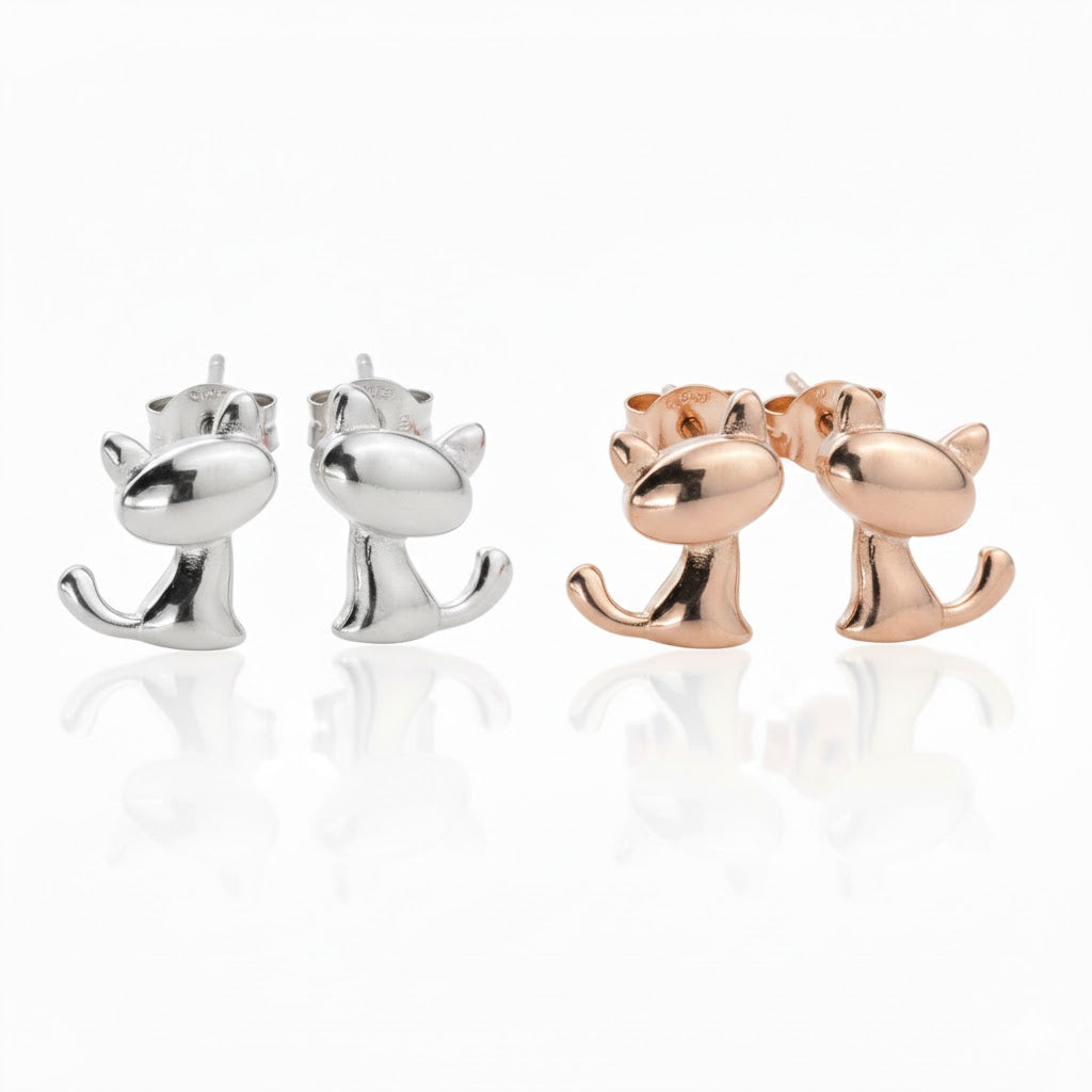 Front view of silver and rose gold cat-shaped stud earrings with their butterfly backs on, on a white background.