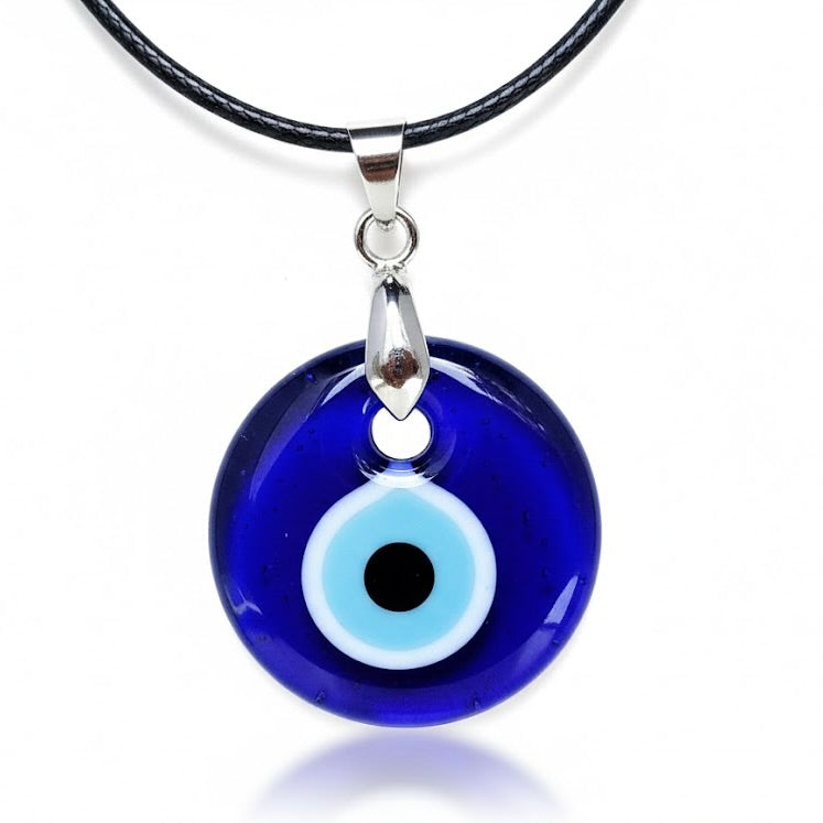 Blue round evil eye pendant made of glass, on a black rope,  on a white background