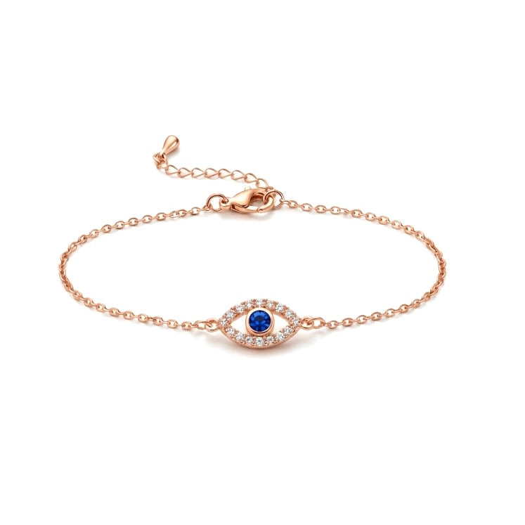 Rose gold bracelet with a blue stone on a white background