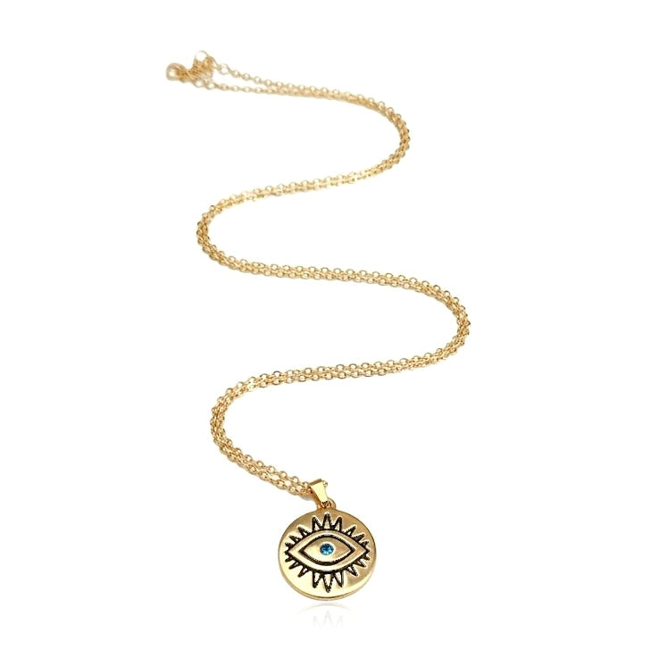 Gold necklace with around evil eye pendant on a white background