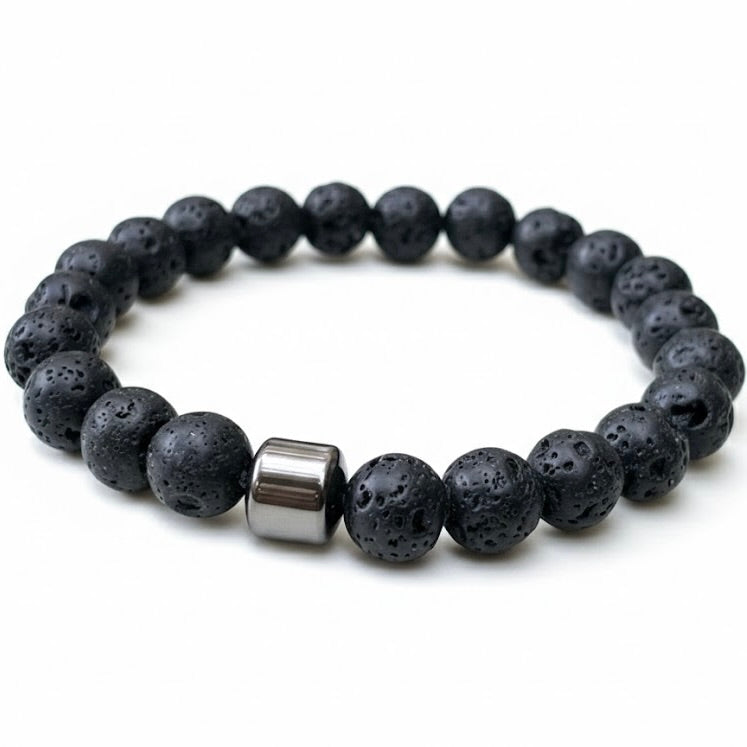 Close up view of the black beaded bracelet with a silver cylindrical bead on a white background
