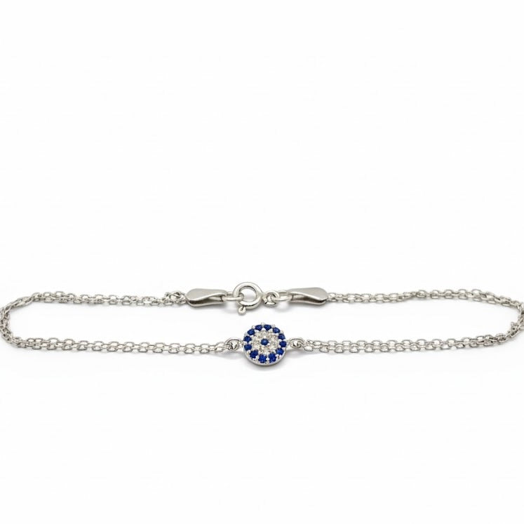 Silver  tiny evil eye bracelet with a blue and clear CZ stones on a white background