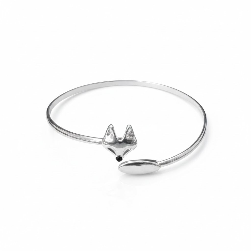 Silver open bangle bracelet with a fox charm on a white background