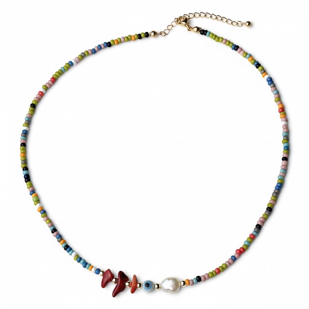Colorful beaded necklace with red agate stones, evil eye bead and a freshwater pearl on a white background