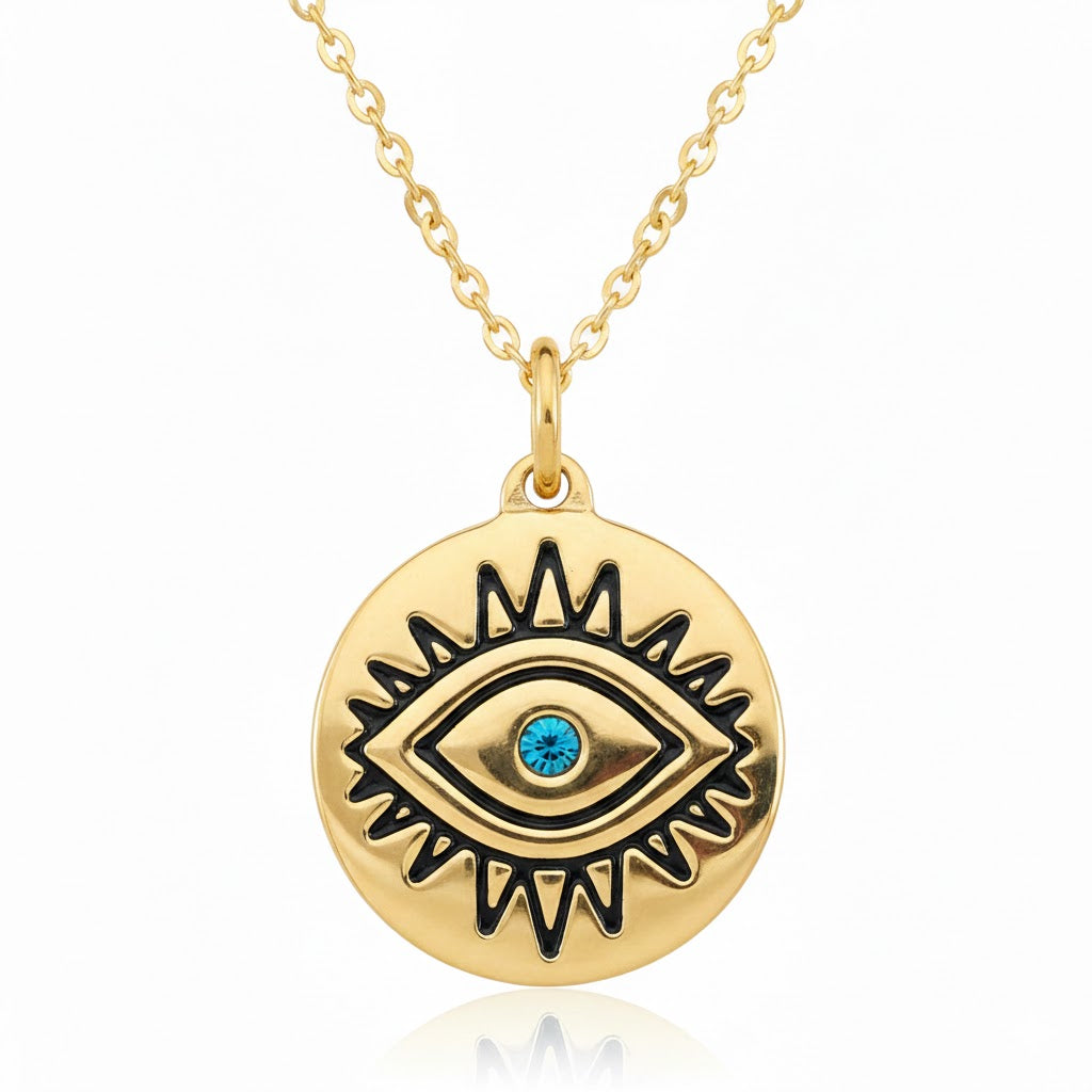 Gold necklace with eye of horus pendant featuring a blue gemstone on a white background