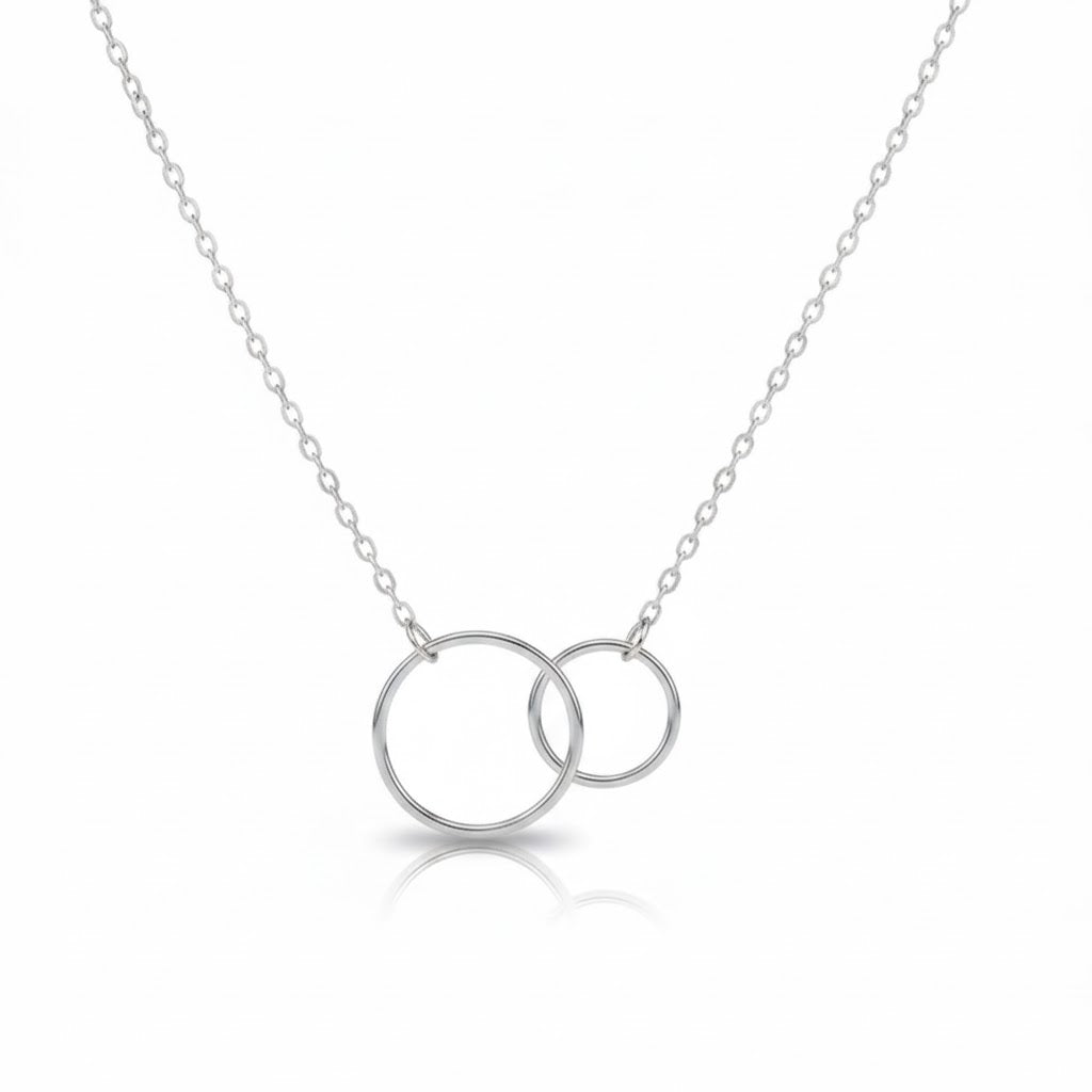 Silver necklace with two interlocking rings on a white background