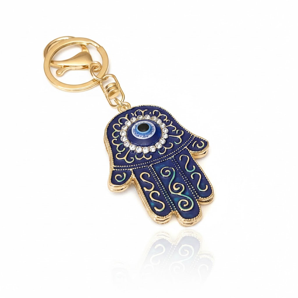 Front view of blue Hamsa keychain with gold accents and on a white background